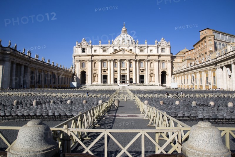 ITALY, Lazio, Rome, Vatican City The Basilica of St Peter with tourists at the entrance and empty seating for the Papal audience in the Piazza San Pietro
