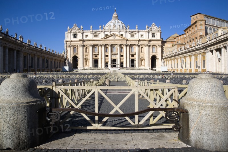 ITALY, Lazio, Rome, Vatican City The Basilica of St Peter with tourists at the entrance and empty seating for the Papal audience in the Piazza San Pietro