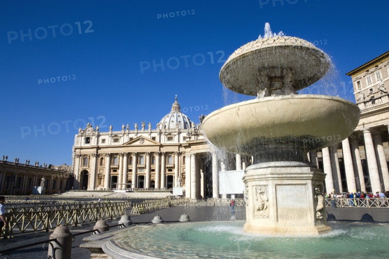 ITALY, Lazio, Rome, Vatican City The Basilica of St Peter and the square or Piazza San Pietro with tourists and a water fountain in the foreground
