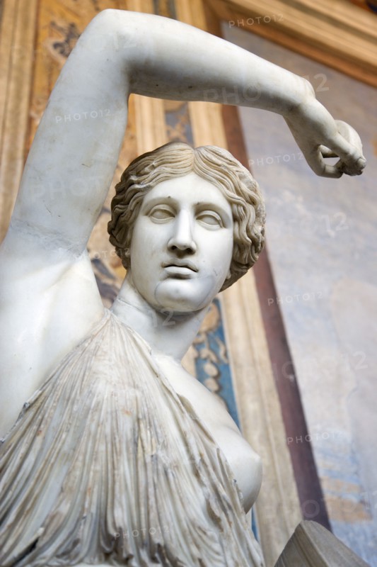 ITALY, Lazio, Rome, Vatican City Museums A statue of a woman raising her arm in the Room of The Busts in the Belvedere Palace