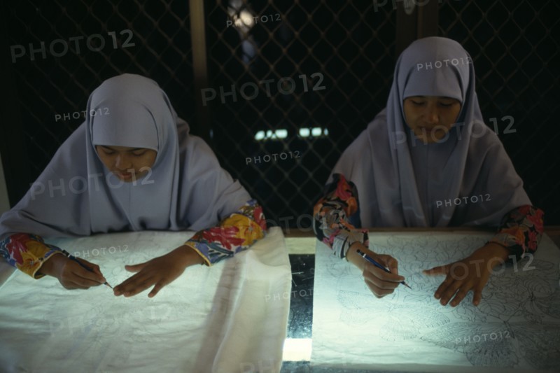 MALAYSIA, Crafts, Young women tracing floral patterns first on to paper then transferring them to silk or satin.