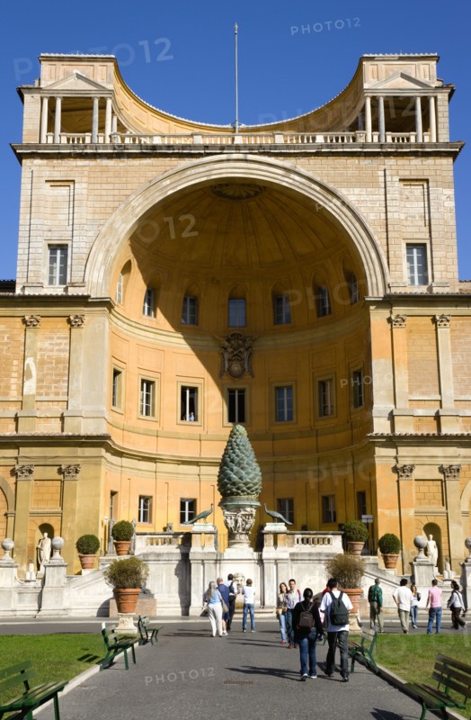 ITALY, Lazio, Rome, Vatican City Museum The central niche designed by Pirro Ligorio in the Belvedere palace housing the Cortile della Pigna a giant bronze pine cone from an ancient Roman fountain with tourists walking in the courtyard