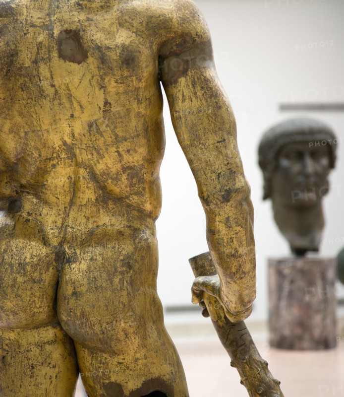 ITALY, Lazio, Rome, The Palazzo dei Conservatori part of the Capitoline Museum with the gilded bronze cult Statue of Hercules of The Forum Boarium in the foreground and the giant bronze head of Constantine beyond