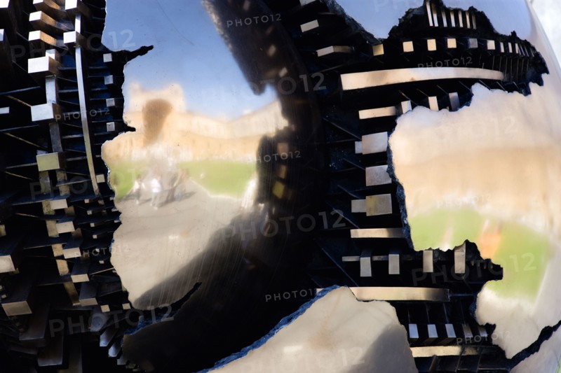 ITALY, Lazio, Rome, Vatican City Museum Detail of the sculpture Sphere Within Sphere by the Italian sculptor Arnaldo Pomodoro in the Cortile della Pigna with the Belvedere Palace reflected