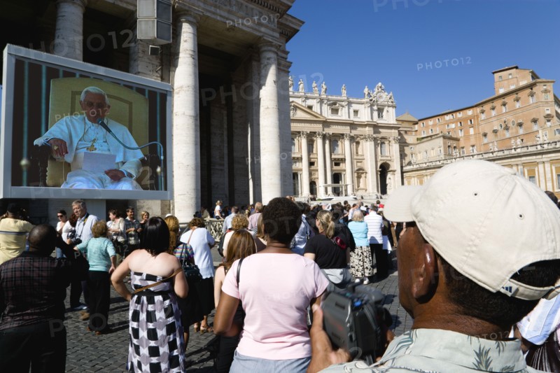 ITALY, Lazio, Rome, Vatican City Pilgrims in St Peter's Square for the wednesday Papal Audience in front of the Basilica watching Pope Benedict XVI Joseph Alois Radzinger on a large video TV monitor display