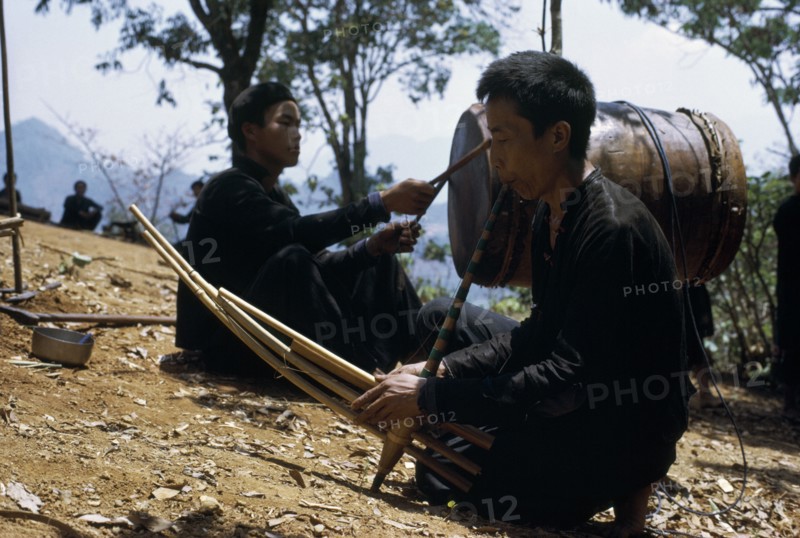 LAOS, Tribal People, Meo Tribe, Meo men playing musical instruments during the traditional ox killing ritual