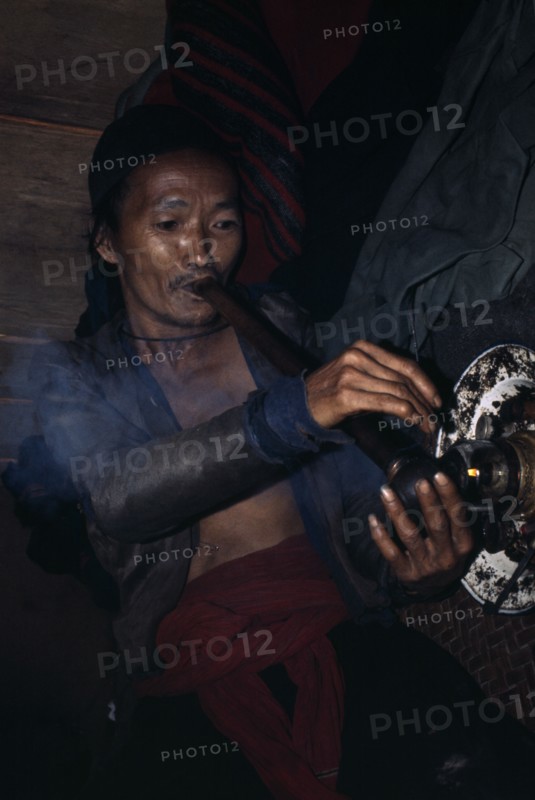 LAOS, Tribal People, Meo Tribe, Meo man smoking Opium