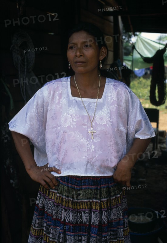 GUATEMALA, Alta Verapaz, Sacaak , Portrait of a Q’eqchi Indian mother wearing a white blouse and a gold crucifix necklace in a Sacaak refugee settlement