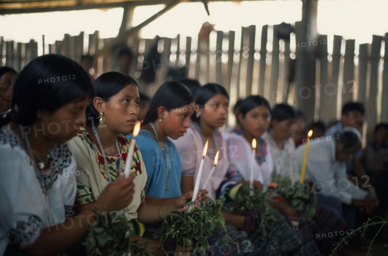 GUATEMALA, Alta Verapaz, Religion, Q’eqchi Indian girls holding candles at Roman Catholic Mass