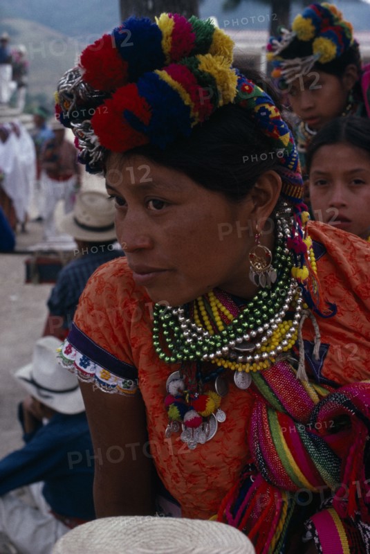 GUATEMALA, El Quiche, San Andres de Sacabaja, Quiche Indian woman wearing traditional colourful dress with beaded necklaces and elaborate head-dress at the San Andres festival