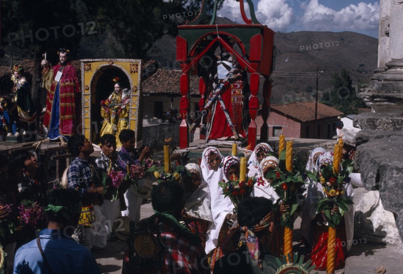 GUATEMALA, El Quiche, San Andres de Sajcabaja, Quiche Indians knelling in prayer to the saints outside the 16th century church during San Andres Festival on December 8th