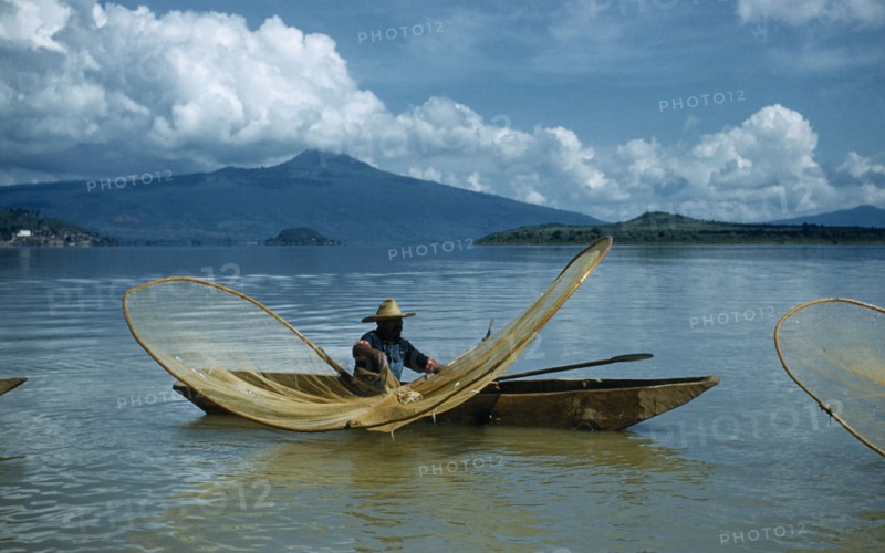 MEXICO, Michoacan, Patzcuaro, Fishermen butterfly net fishing from canoes on Lake Patzcuaro