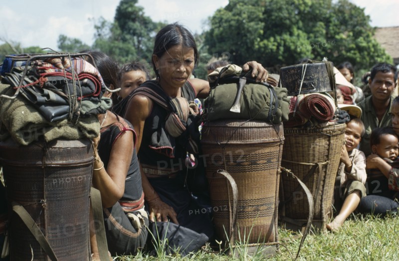 VIETNAM, Central Highlands, Kontum, Vietnam War. Montagnard refugee families waiting to be shipped back to their villages outside the battle zone.20092421