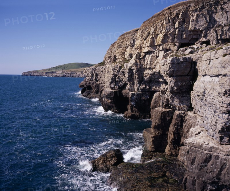 ENGLAND, Dorset, Jurassic Coastline, View west from Dancing Ledge towards Seacombe Quarry with grassy hilltop of East Man circa 107 metres  (350 feet)