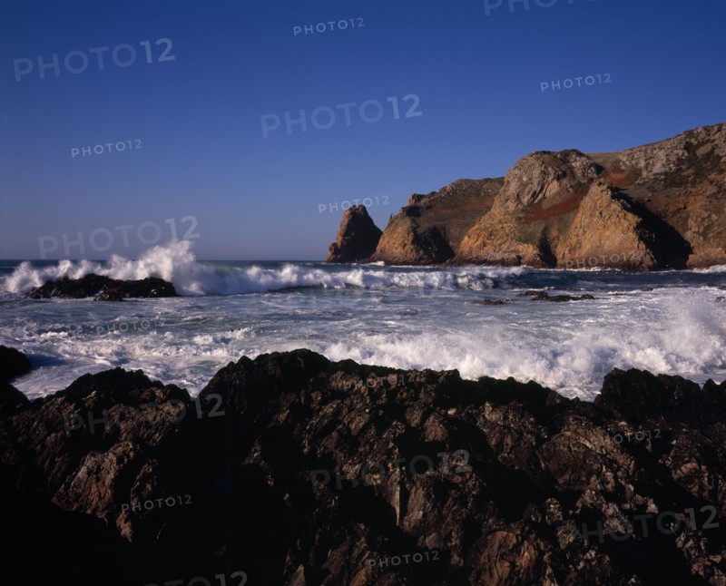 UNITED KINGDOM, Channel Islands, Jersey, St Ouen. Le Pulec. Rough sea with waves crashing against rocky foreshore