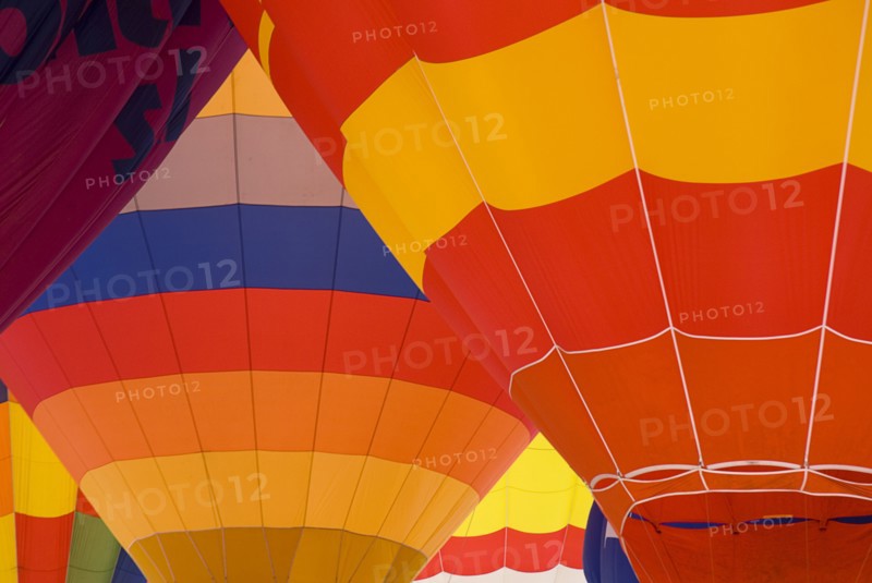 SWITZERLAND, Canton de Vaud, Chateau d'Oex, Patterns of a number of inflated Hot Air Balloons close together.