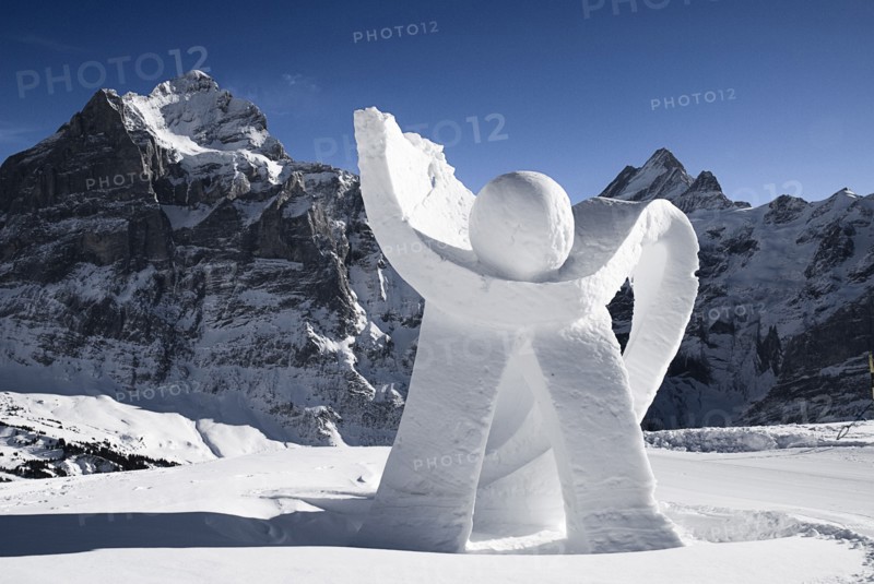 SWITZERLAND, Bernese Oberland, Grindelwald, Ice sculpture at Grindelwald First summit station with Eiger mountain behind.