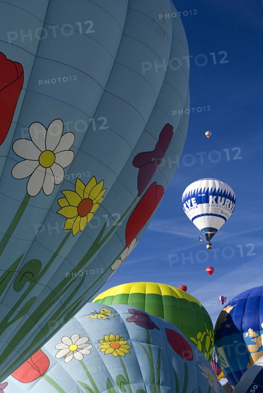 SWITZERLAND, Canton de Vaud, Chateau d'Oex, Hot Air Balloons taking off and framed by sections of other balloons.