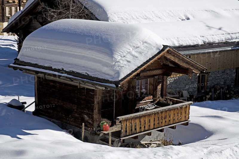 SWITZERLAND, Bernese Oberland, Murren, Snow covered house in the centre of Murren town.