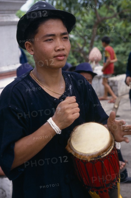 LAOS, Luang Phrabang, Portrait of drummer celebrating the lunar New Year.