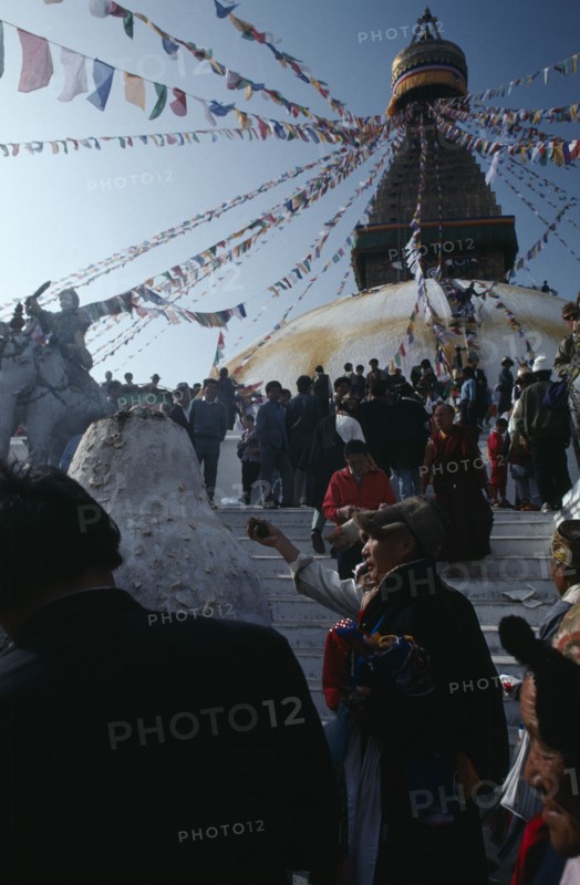 NEPAL, Kathmandu, Bodhanath, Crowd of Tibetans offering incense on the steps of the main stupa during New Year celebrations.