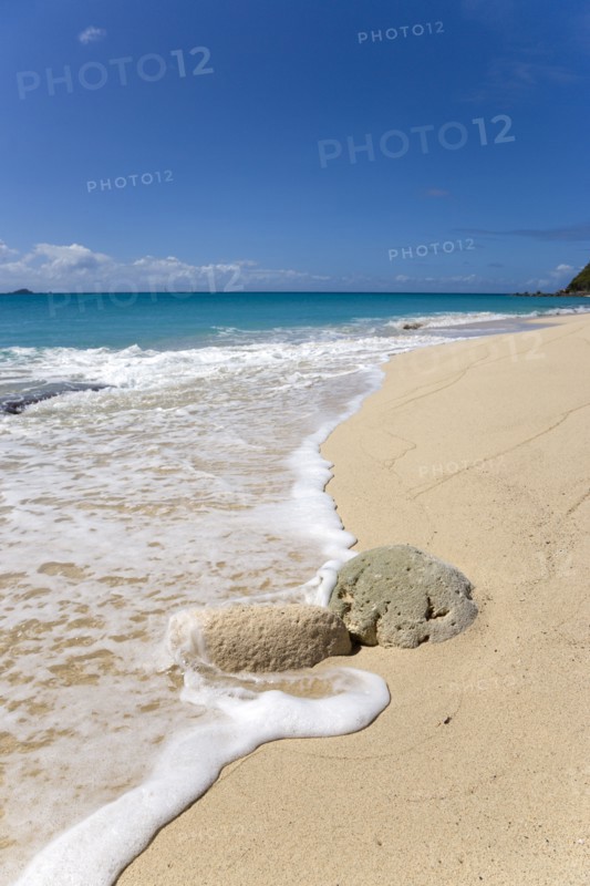 WEST INDIES, St Vincent And The Grenadines, Canouan, South Glossy Beach in Glossy Bay with waves breaking on the shoreline of the turqoise sea and yachts on the horizon