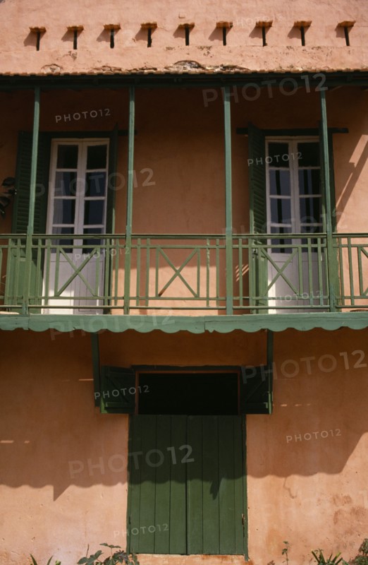 SENEGAL, Goree Island, "Detail of house with a green balcony, shutters and door"