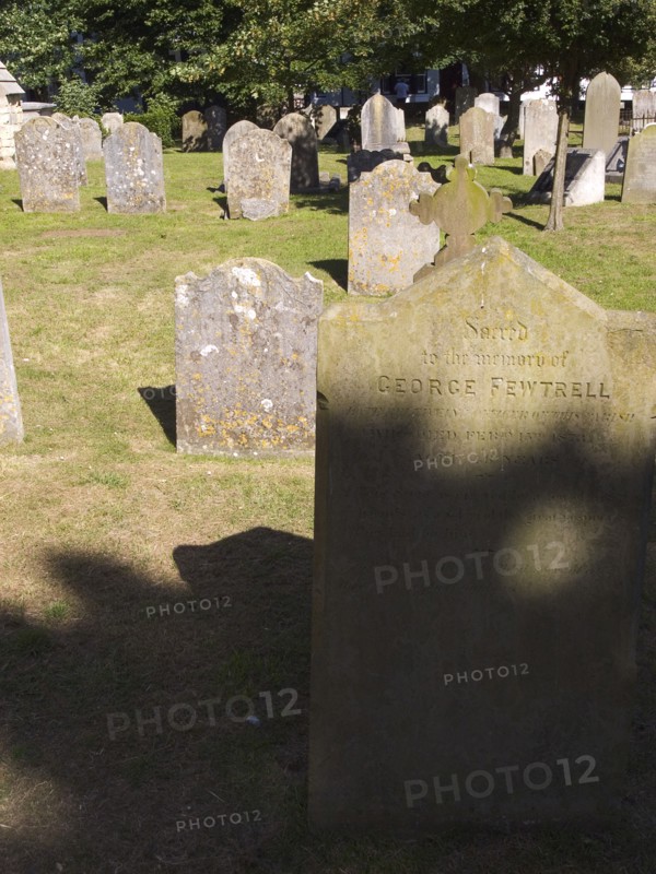 ENGLAND, West Sussex, Shoreham-by-Sea, Weather worn headstones in the cemetery of the Church os St Mary de Haura.