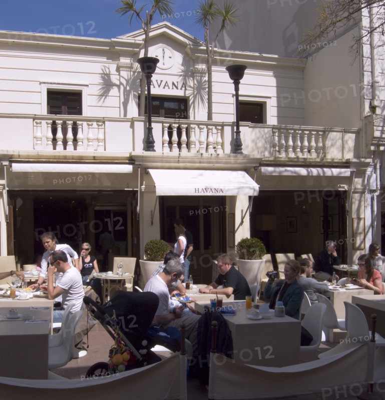 ENGLAND, East Sussex, Brighton, People sat outside the Havana restaurant in Duke Street.