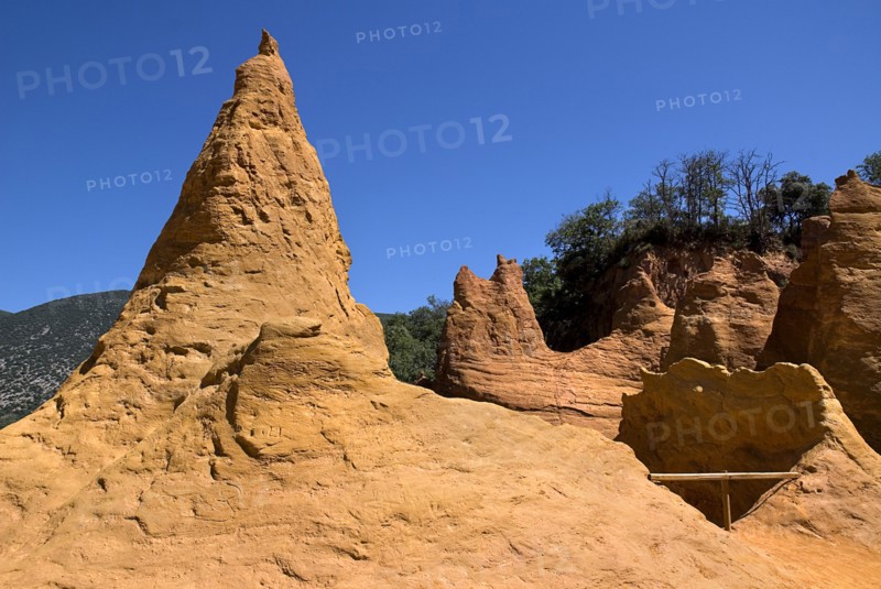 FRANCE, Provence Cote d’Azur, Vaucluse, Colorado Provencal.  Cheminee de Fee or Fairy Chimneys.  General view from summit of eroded ochre rock cliff and peaks.