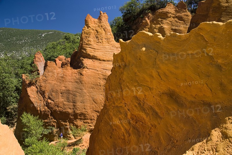 FRANCE, Provence Cote d’Azur, Vaucluse, Colorado Provencal.  Cheminee de Fee or Fairy Chimneys.  Area of eroded ochre rock cliffs and pinnacles from viewpoint.