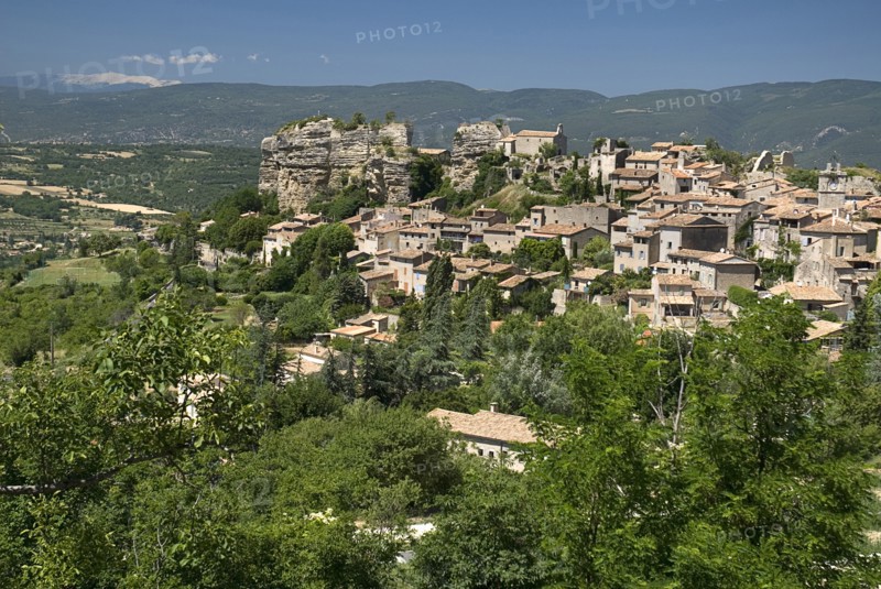 FRANCE, Provence Cote d’Azur, Vaucluse, "Saignon.  Provencal hilltop village with Mont Ventoux seen in the distance, top left."