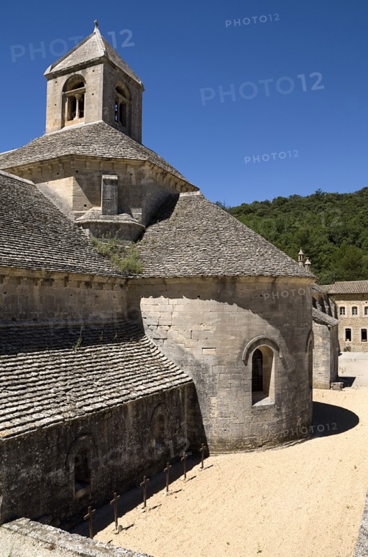 FRANCE, Provence Cote d’Azur, Vaucluse, Abbaye Notre Dame de Senanque.  Exterior view of chapel and courtyard of twelth century Cistercian monastery.  Known as one of the Three Sisters of Provence together with the Romanesque and Silvacane abbeys.
