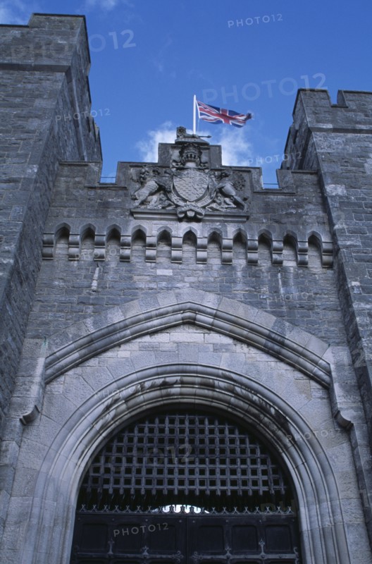 ENGLAND, West Sussex, Arundel, Arundel Castle. Part view of the entrance gate and crenelated towers with Union Jack flag flying above.