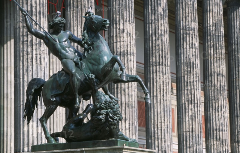 GERMANY, Berlin, Bronze equestrian statue entitled The Lion Fighter by Albert Wolf in 1847 outside colonnaded facade of the Altes Museum designed by Karl Friedrich Schinkel.