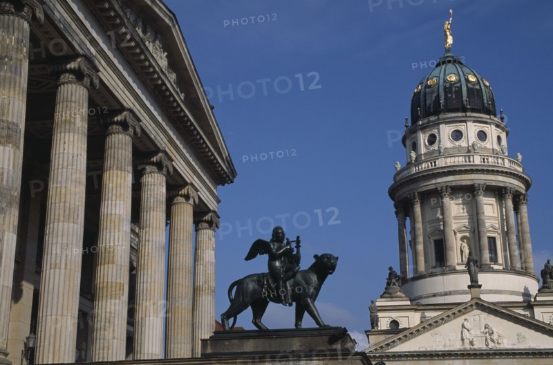 GERMANY, Berlin, Gendarmenmarkt.  Statue of winged Bacchus riding a panther in front of the Konzerthaus with the Franzosischer Dom on right.
