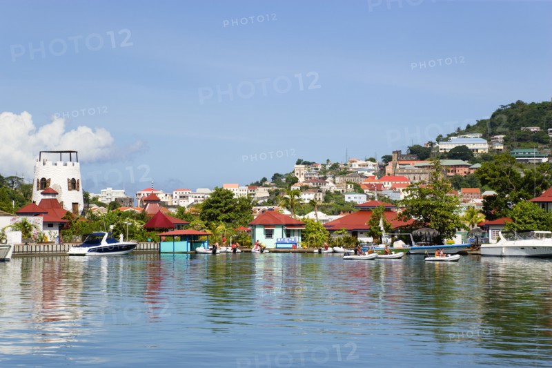 WEST INDIES, Grenada, St George, The new Peter de Savary marina development of Port Louis with the capital city of St George's beyond. Eco tourists in rubber dingies leave the jetty to explore the coastline