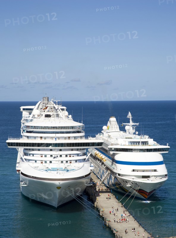 WEST INDIES, Grenada, St George, Two cruise ships the Caribbean Princess and Aida Aura moored at the cruise ship terminal in the capital city of St George's with passengers walking along the jetty between the liners