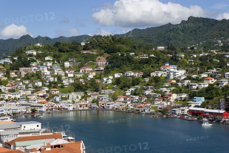 WEST INDIES, Grenada, St George, The Carenage harbour of the capital city of St George's surrounded by hills lined with houses and other buildings
