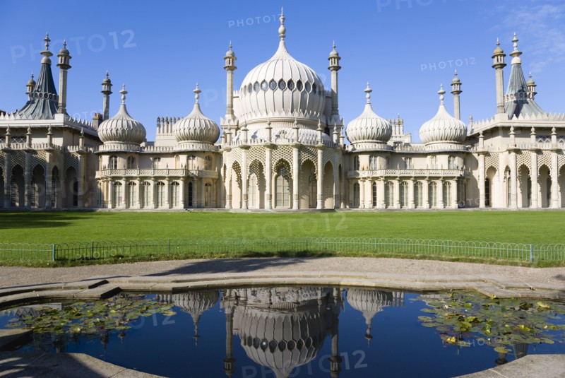 ENGLAND, East Sussex, Brighton, The onion shaped domes of the 19th Century Pavilion designed in the Indo- Saracenic style by John Nash commissioned by George Prince of Wales later to become King George IV. The oval water lilly pond in the foreground