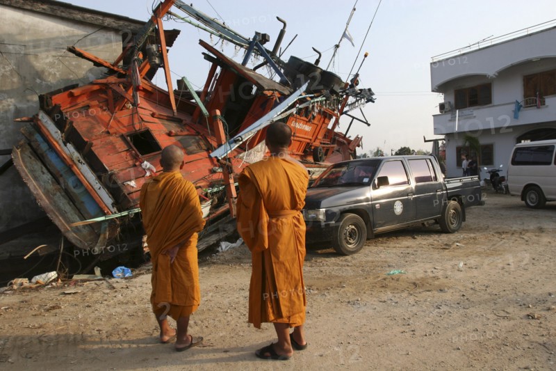 THAILAND, Phang Nga District, Nam Khem, "Tsunami. Monks looks at the damage caused by the tsunami, nothing is left standing in the village 2500 people are pressumed dead. 125kms north of Phuket on the 2nd Jan."
