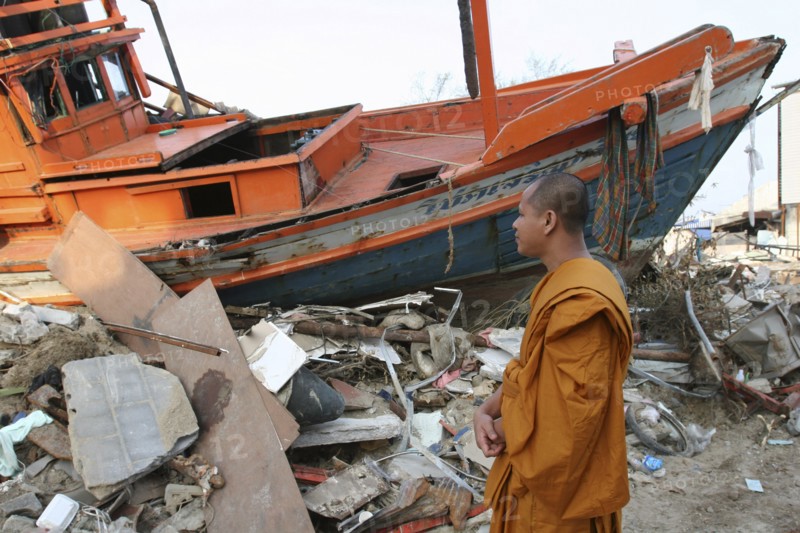 THAILAND, Phang Nga District, Nam Khem, "Tsunami. Monk looks at the damage caused by the tsunami, nothing is left standing in the village 2500 people are pressumed dead. 125kms north of Phuket on the 2nd Jan."