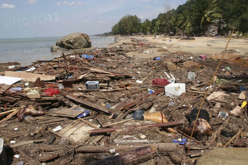 THAILAND, Phuket, "Tsunami. Bodies lay mixed with all the debris on the beach caused by the dissaster. Now the devestation can be seen in the remote areas. This was about 60kms north of Phuket at Khaolak Beach with the destruction of Khaolak Resort in the background, where the whole coastline looks like this and bodies are being found all the way along. On the 28th Dec."
