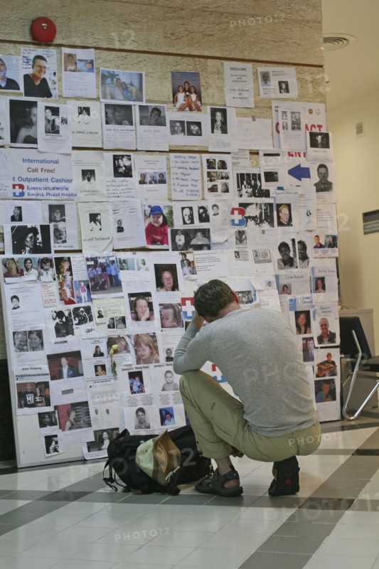 THAILAND, Phang Nga District, Phuket, "Tsunami. A french tourist grieves while looking at pictures of french people missing along with hundereds of others posted up at the Bangkok Phuket hospital, on the 5th Jan."