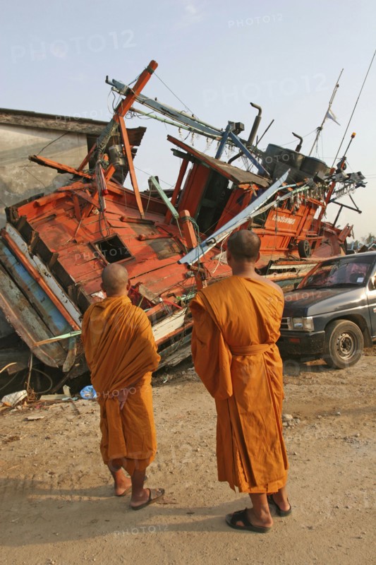 THAILAND, Phang Nga District, Nam Khem, "Tsunami. Monks looks at the damage caused by the tsunami, nothing is left standing in the village 2500 people are pressumed dead. 125kms north of Phuket on the 2nd Jan"