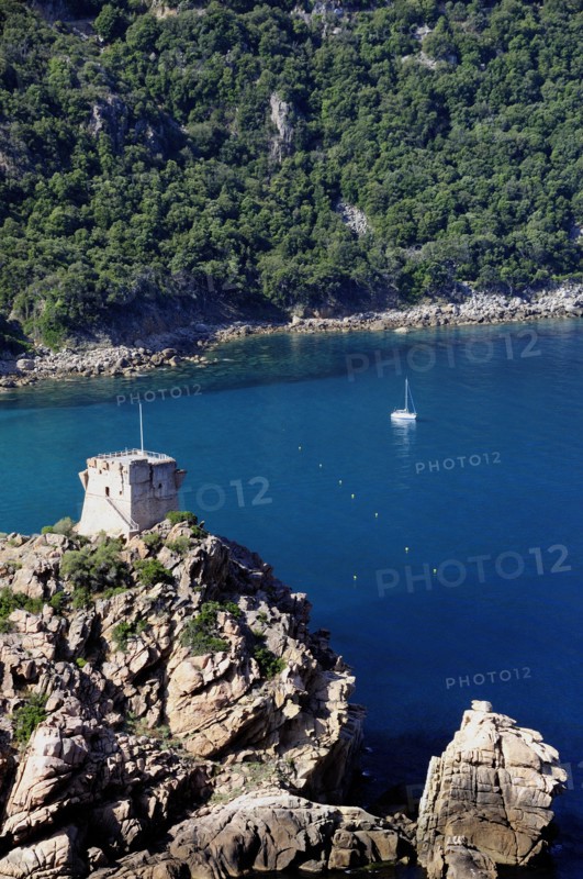 FRANCE, Corsica, Golfe Di Porto, "Porto, Genoese tower on rocky headland with blue waters & boats"