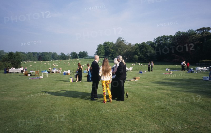 ENGLAND,  East Sussex, Glyndebourne, Opera attendees enjoying picnics in the gardens during performance interval