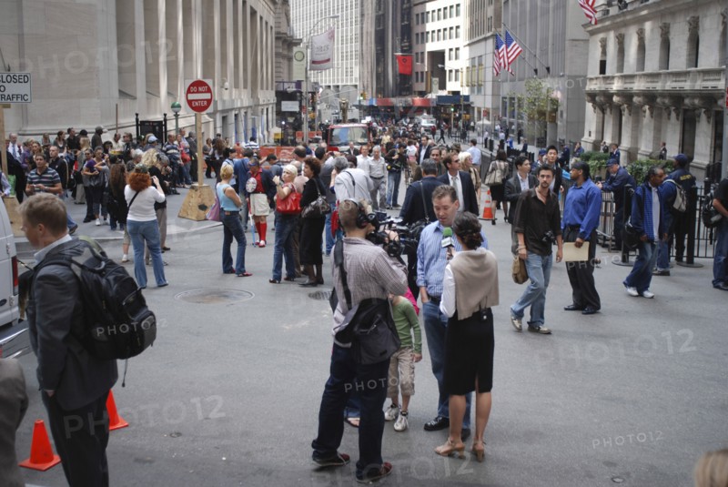 USA, New York, Manhattan, "Financial District, Wall Street, Crowds of people and news reporter television crews outside the NY Stock Exchange building."