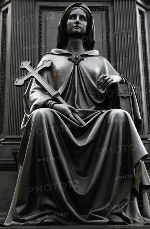 GERMANY, Saxony, Dresden, "Neumarkt, detail of female figure holding a cross at the base of the bronze Statue of King Friedrich August II by Ernst Julius Handel 1867."