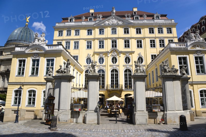 GERMANY, Saxony, Dresden, The glass dome of the Academy of Arts built 1891-94 on the Brhl Terrace by Constantin Lipsius in the style of the Neo-Renaissance behind the Baroque courtyard entrance to the Coselpalais which is now a restuarant busy with diners seated at tables under umbrellas.